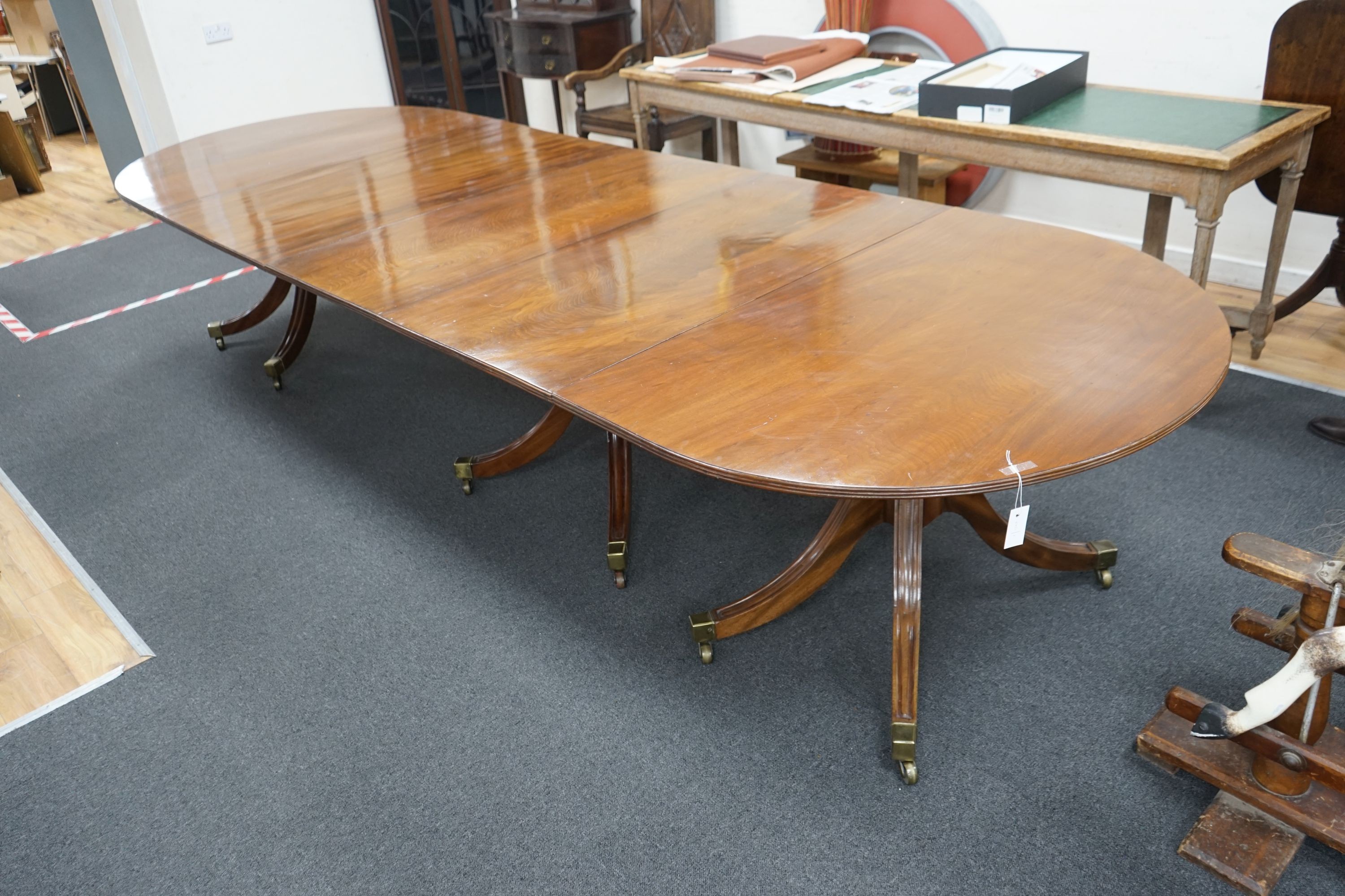 A George III and later mahogany three pillar D end extending dining table, one spare leaf, 376cm extended, width 128cm, height 72cm